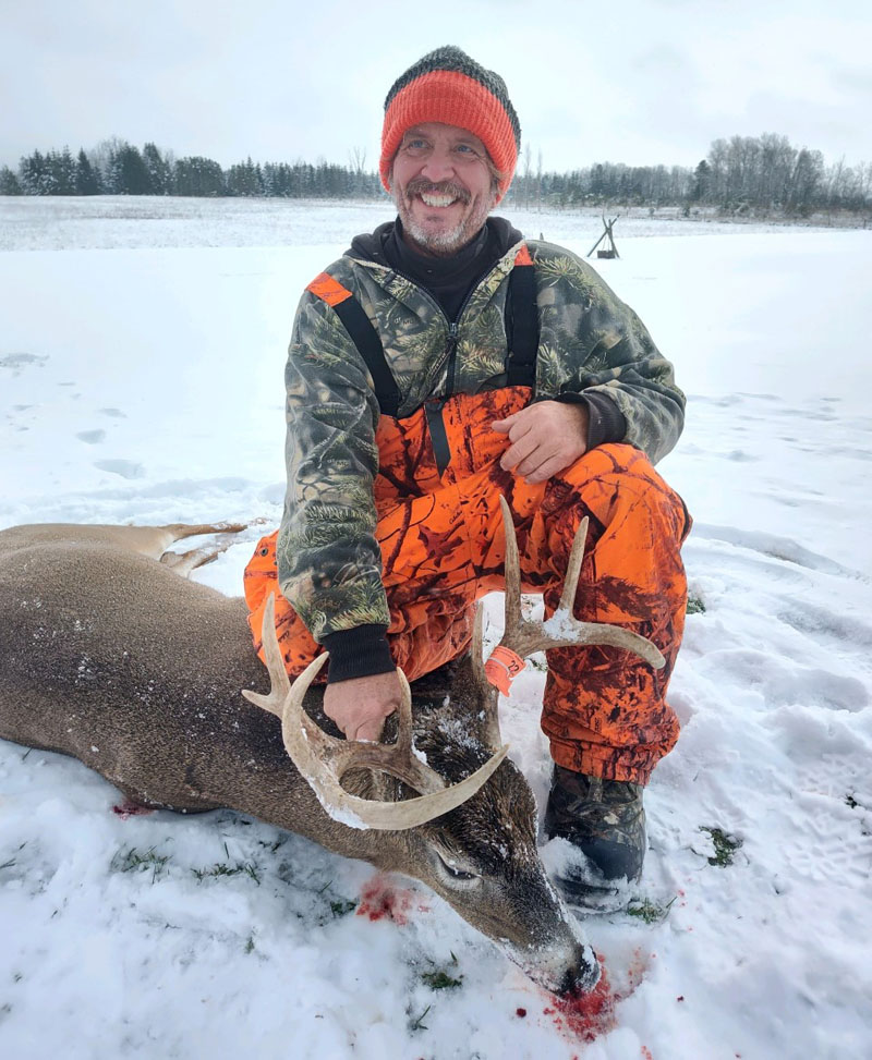 deer hunter and buck