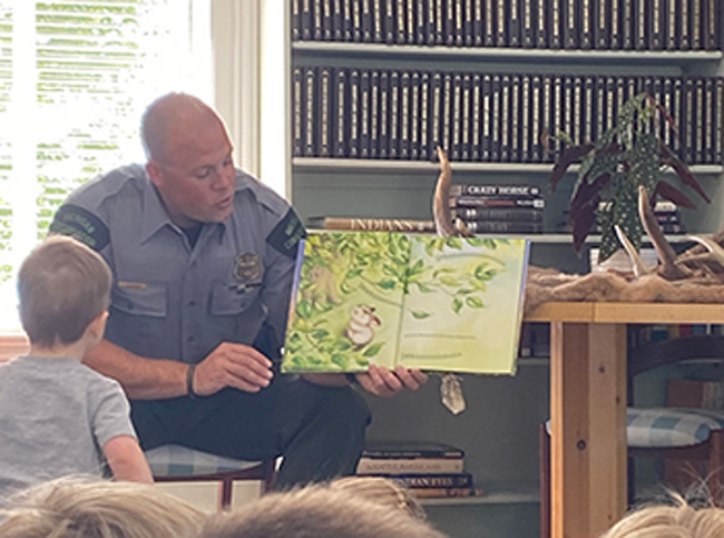 conservation officer reading at library