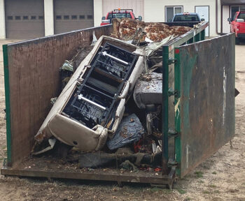 dumpster with trash from clean up