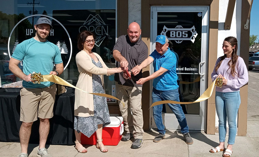 ribbon cutting ceremony in front of storefront