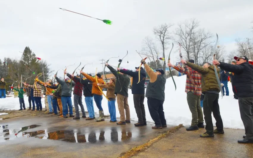 Group of men shooting arrows from bows