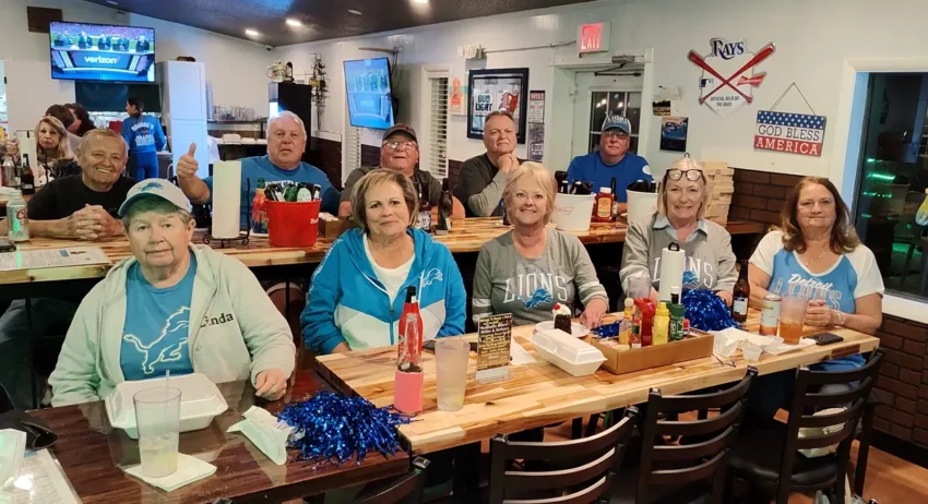 Group photo of people sitting in diner to watch the game