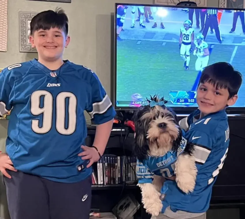 Kids and their dog with Lions jerseys