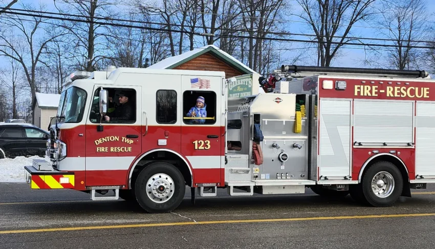 Denton Township Fire and Rescue truck with little girl looking out window