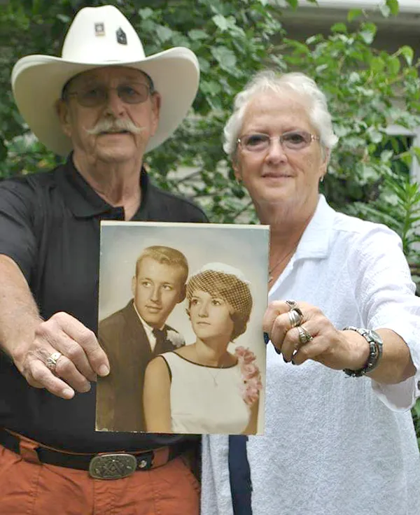 Bill and Sherry Haag holding early photo of themselves