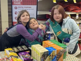 Girl Scouts selling cookies at store
