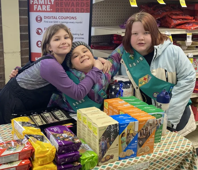 Girl Scouts selling cookies at store