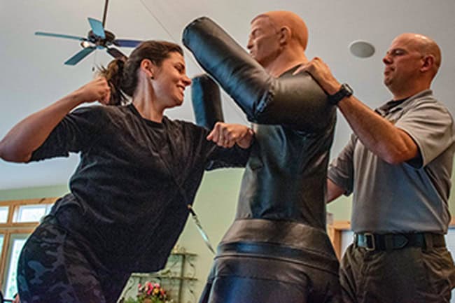 350confidence_original woman readies her fist to punch a dumm