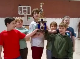 youth archers holding a trophy
