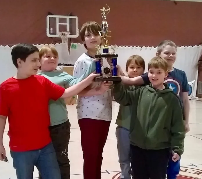 youth archers holding a trophy
