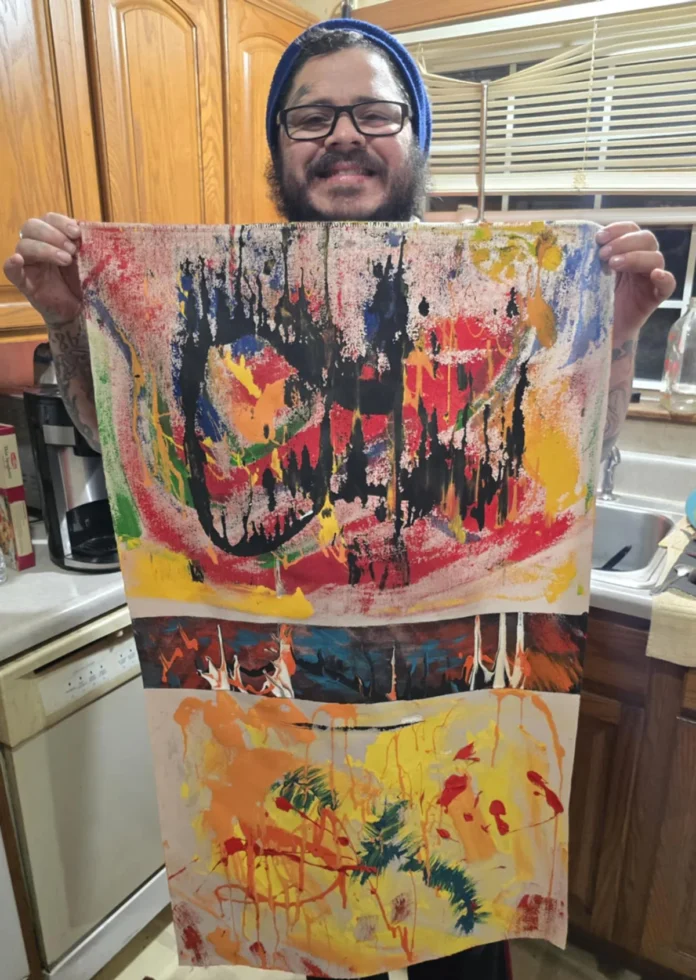 Vargas holding a painting
