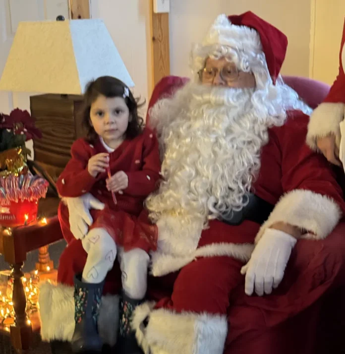 mio christmas pic 2 Olivia Kachiros is pictured with Santa.