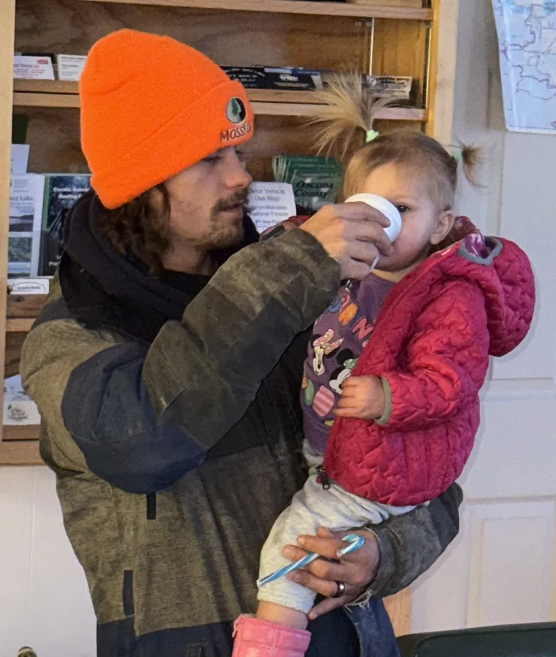 Neaveh Fox gets a sip of water from Josh Fox.