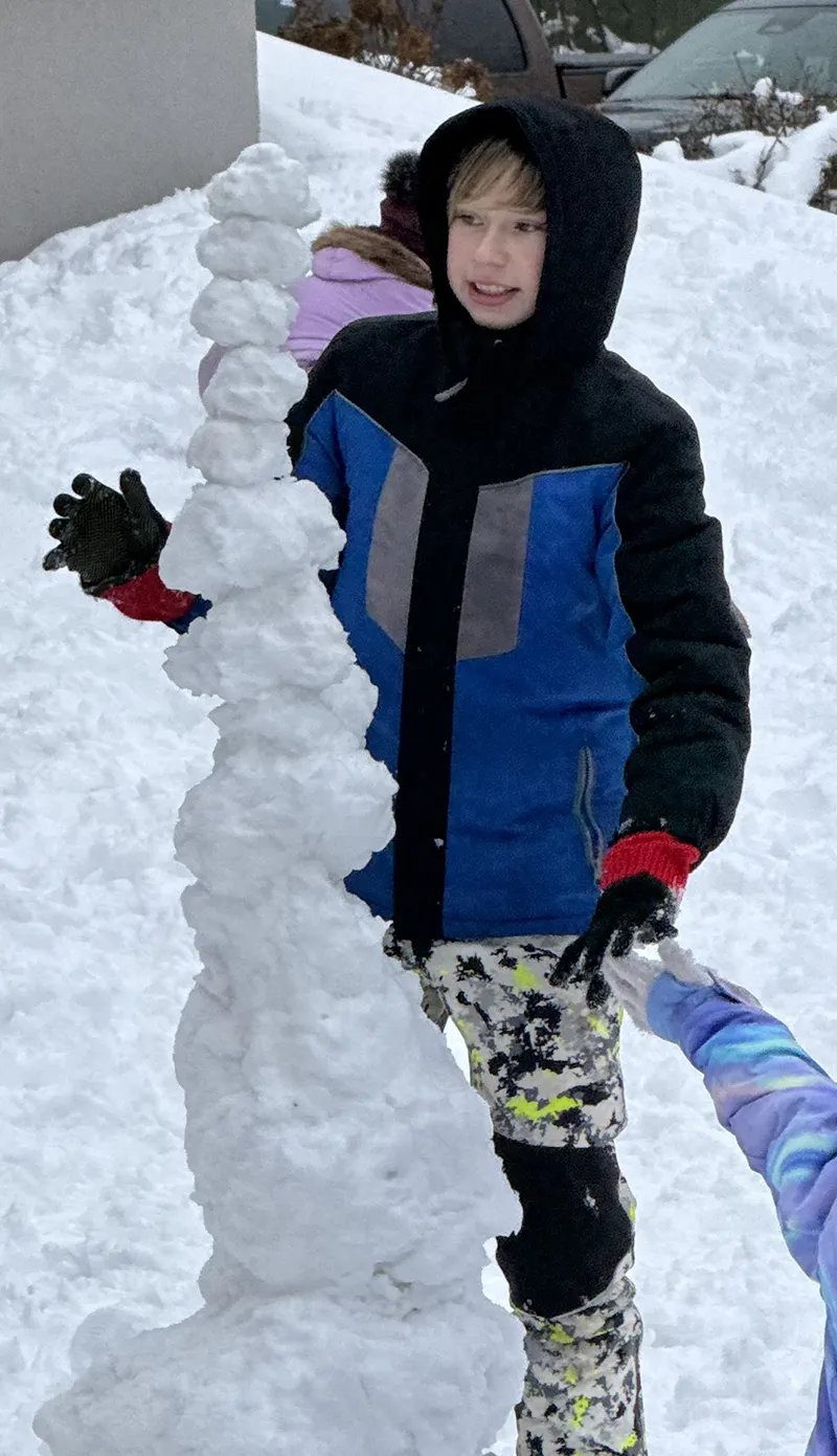 While waiting for the Santa Train, Beau Hartig built a snowman.