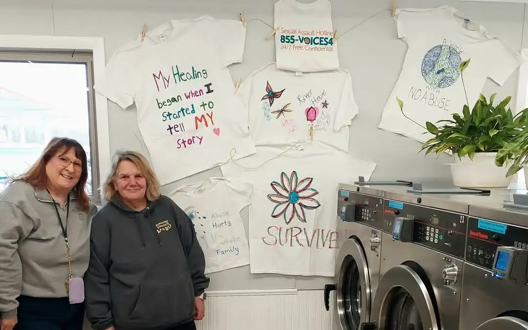 Coordinator Karen Lewandowski (left) and Jackie Moore of Roscommon Cleaners and Laundry (right) with their Clothesline display.