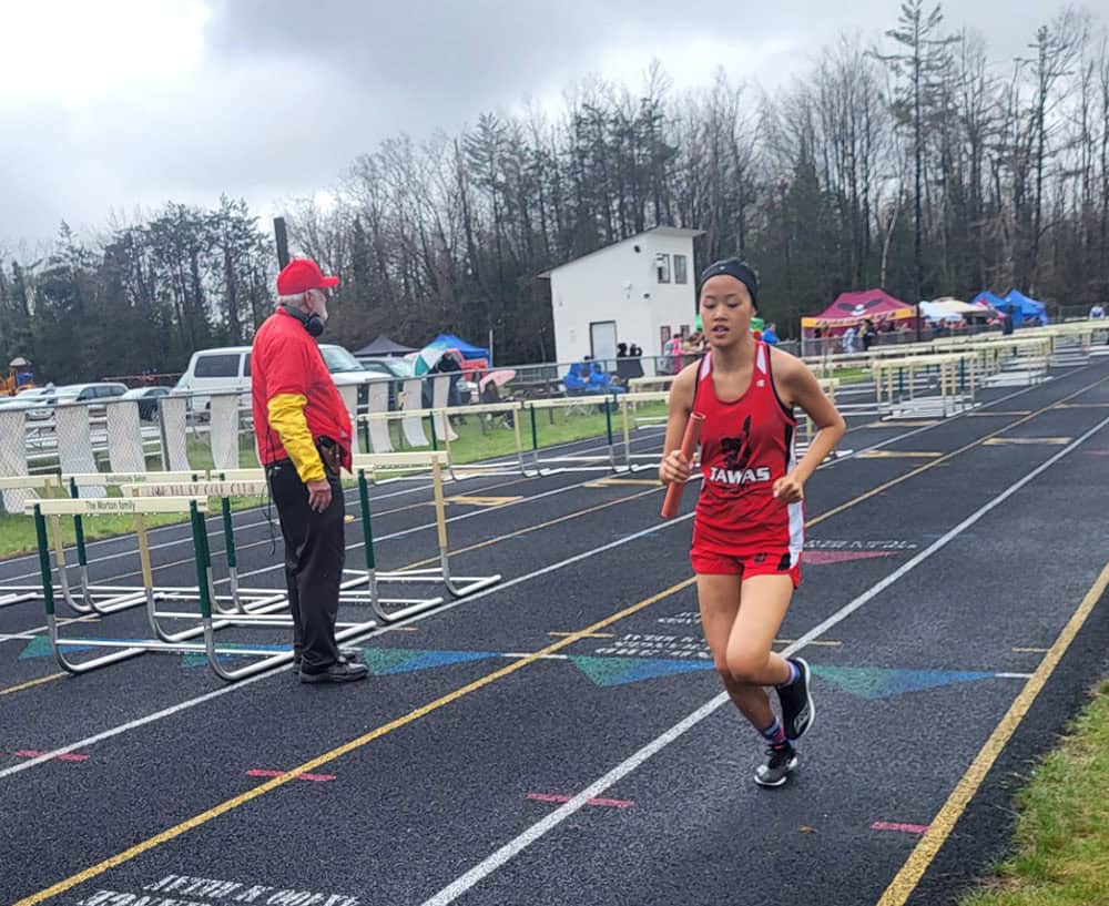Tawas Senior Ashley Nguyen competing in the 4x8 relay.