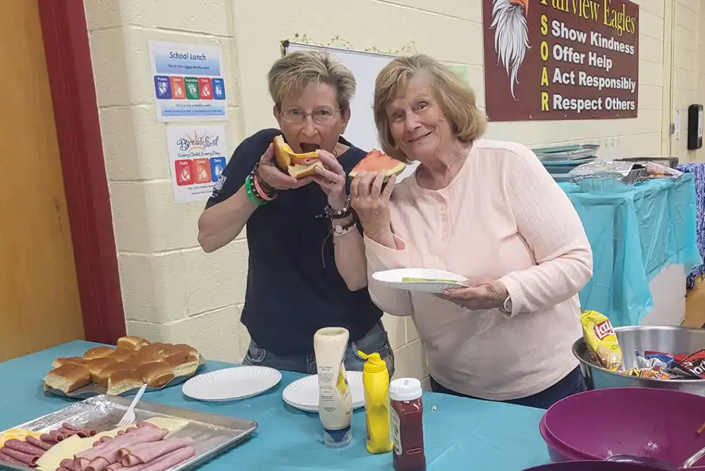 Current Lydia's Gate resident Brenda Janosko with silent auction participant Sue Byers enjoying the snack table.