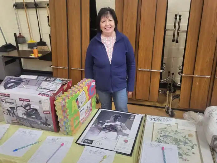 Event volunteer Vicky Pettry helping out with the silent auction.