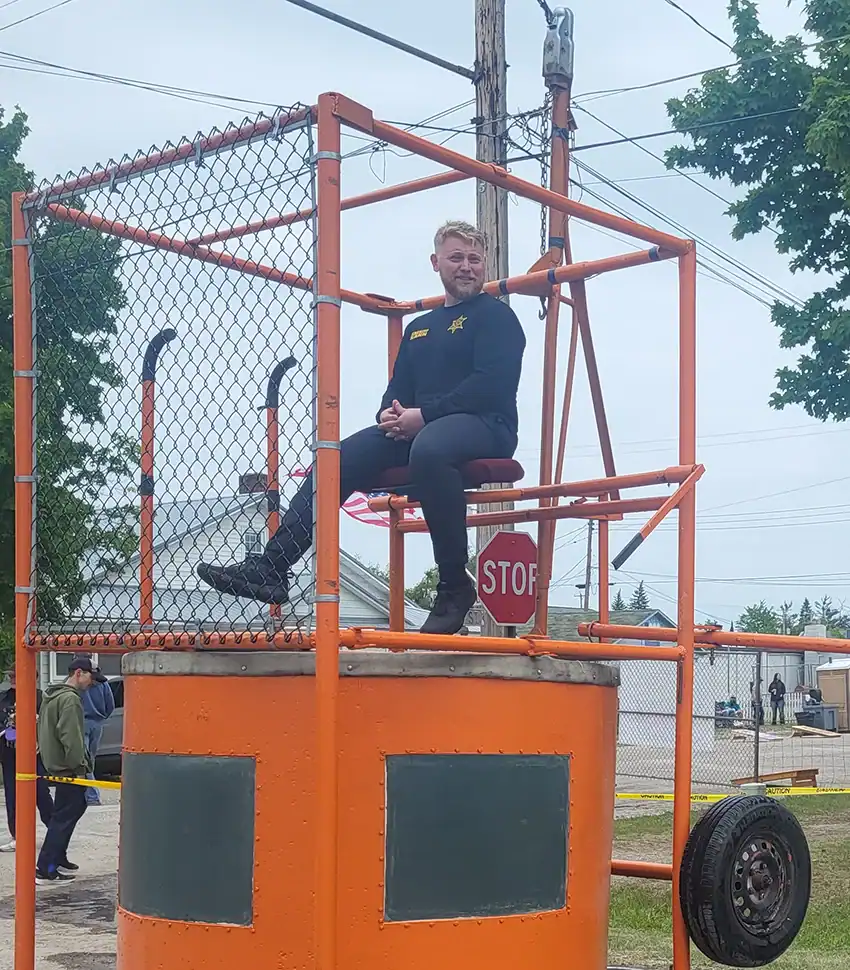 Oscoda County Sheriff Taylor Kann in the dunk tank. Dunk a cop proceeds went to the Committee to Promote Public Safety scholarship.