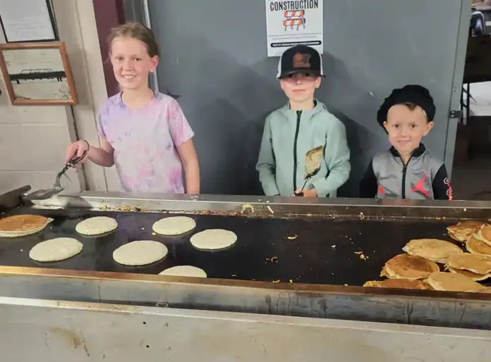 steiner 1 Pictured is Naomi Yoder cooking up pancakes with her brothers Enoch and Benaiah.