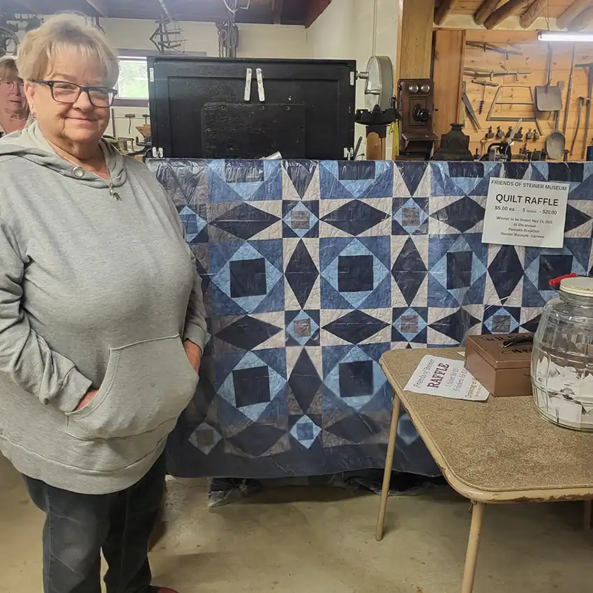 Pictured is museum volunteer Sue Perry raffling off a quilt she made with proceeds going toward the museum.