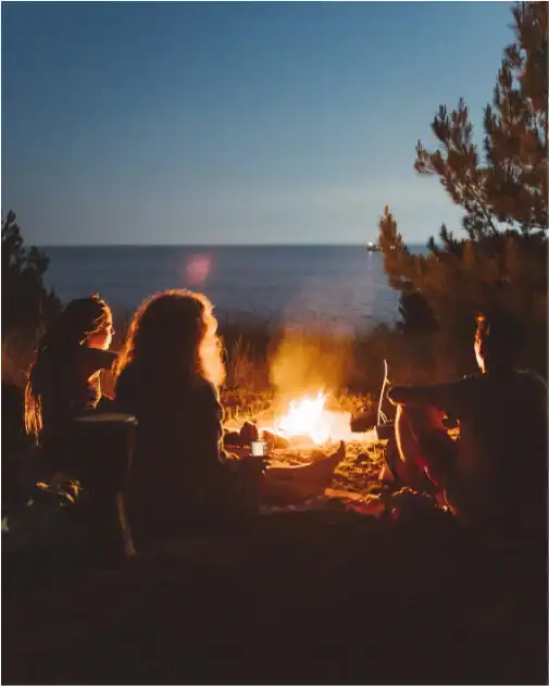 fire danger group sitting around a campfire