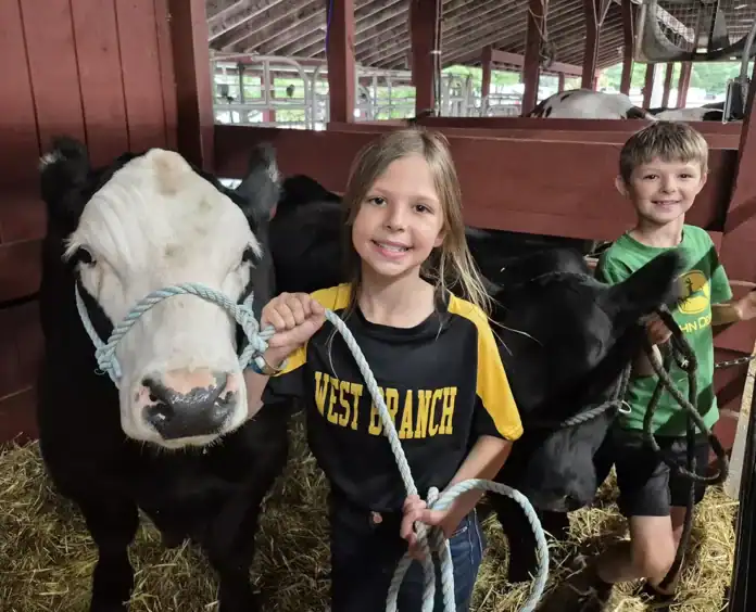 ogemawfair-pic 3 (1) Aubrey Rau (10) with her steer Hades, and her brother Charles (9) with his heifer Willow getting ready for the cattle judging at the Ogemaw County Fair.