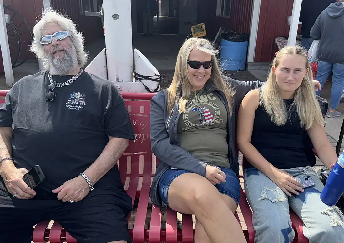 Taking a break from the heat were (l-r) Ron Haven, Jennifer Arnold and Trinniti Arnold. Trinity sang the National Anthem at the Fireman's Memorial Grounds after Saturday's parade.