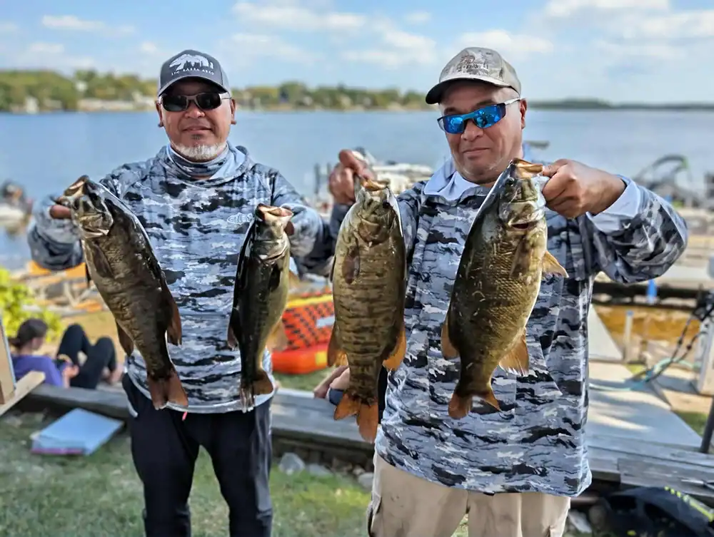 fishermen holding fish caught at sage lake