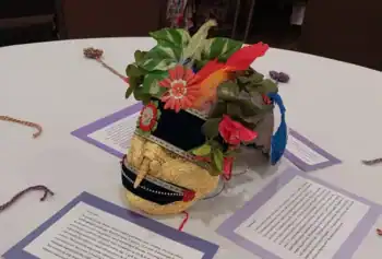 Survivors' centerpieces reflected the contrast between outer appearance and inner emotion, with cards explaining the mask-making process and its meaning.
