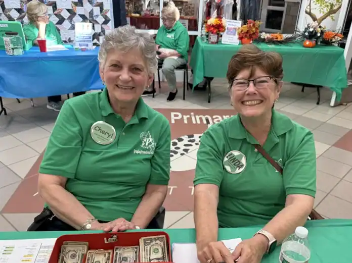 Cheryl LaDuke and Linda Northrop met people at the front door.