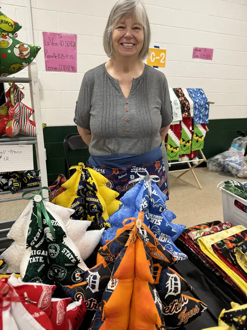 Donna Duvernois is pictured with a variety of Christmas Trees she created.