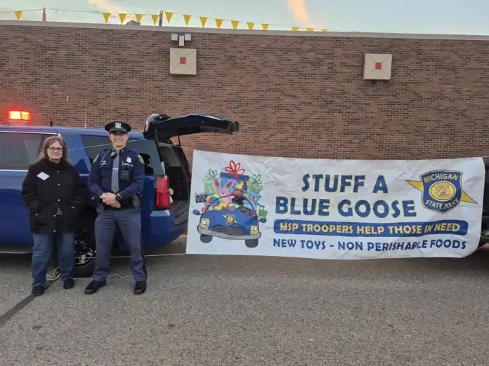 blue goose Pictured is Food Pantry Secretary Mary Ulrich with MSP Trooper Jason Kunath.