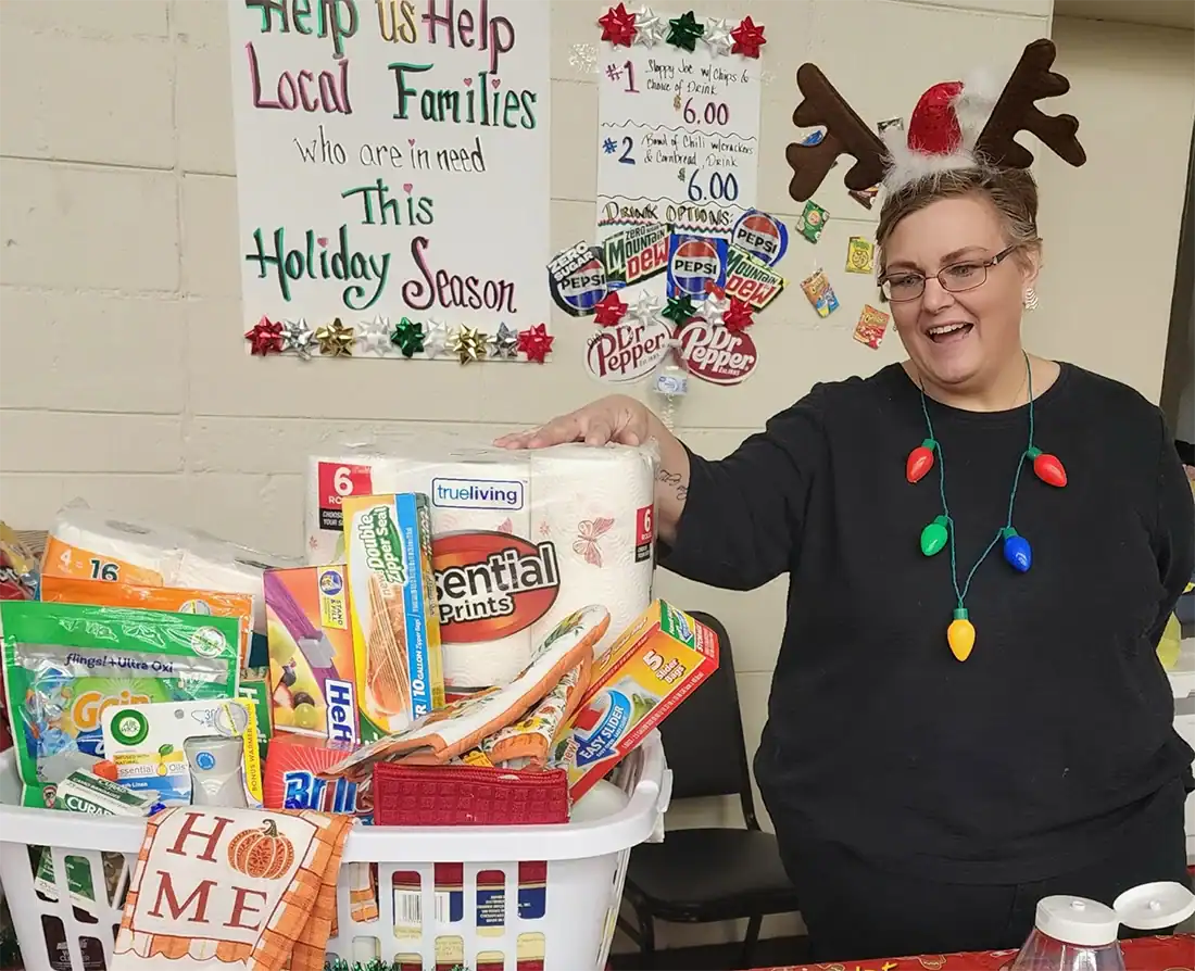 Tina Biggs of South Branch manned the food table that generates funds for the food banks. Biggs is the Operations Coordinator for ICCOA which provides food for four centers.